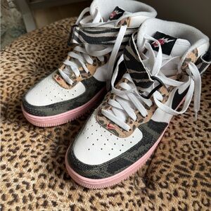 Nike White Sneakers with Black Accents. Nike Air Jordan’s high tops